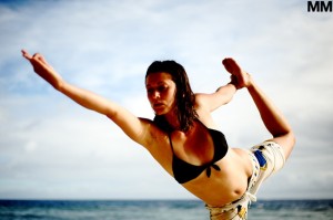Adina doing yoga on the beach